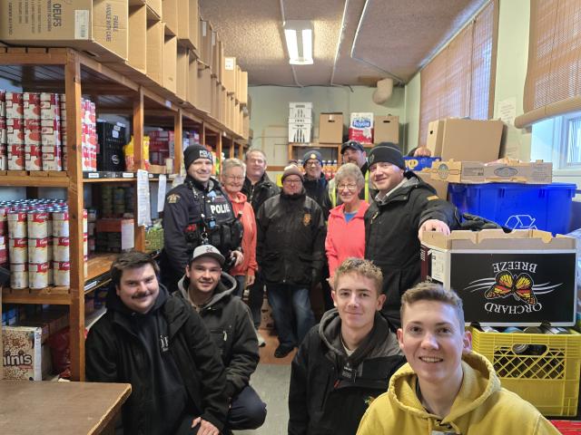 Members of the Dauphin RCMP, Dauphin Fire Department, and Food Bank Volunteers