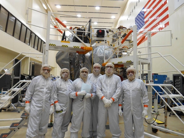 Leif Bloomquist (second from the left) installing the Laser Altimeter on board the OSIRIS-REx spacecraft.